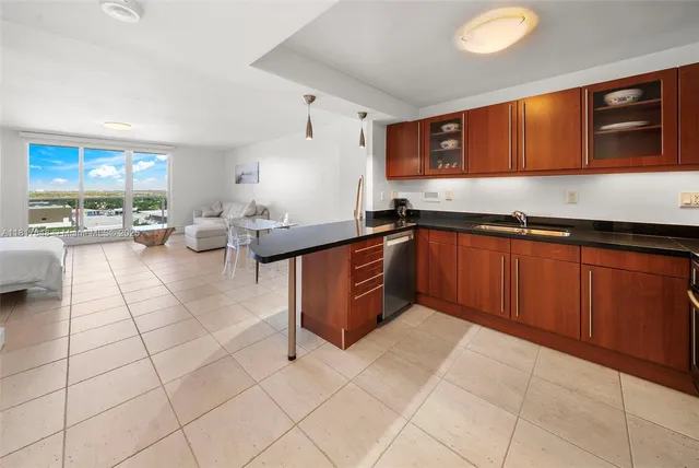 a kitchen with stainless steel appliances granite countertop a sink and cabinets