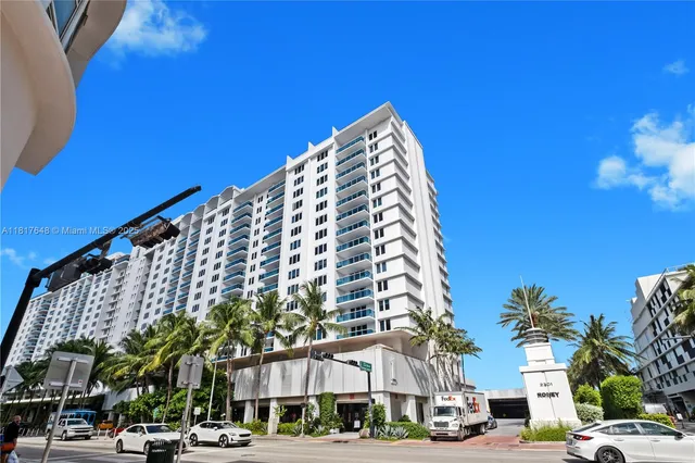 a view of a tall building next to a road