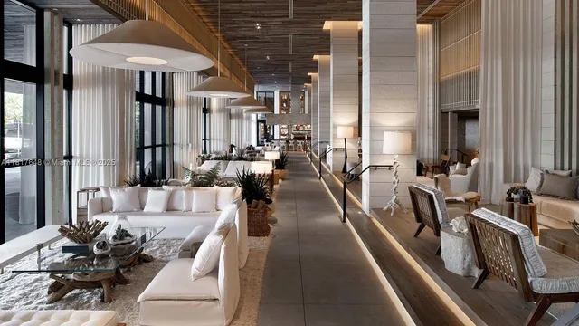 a living room with furniture a rug and white walls