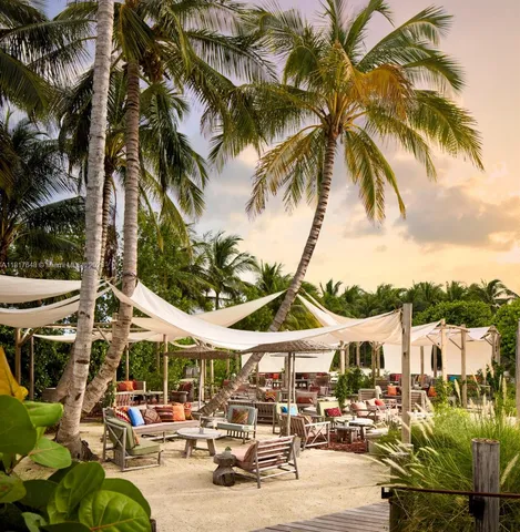 a view of a dining room with furniture and a floor to ceiling window