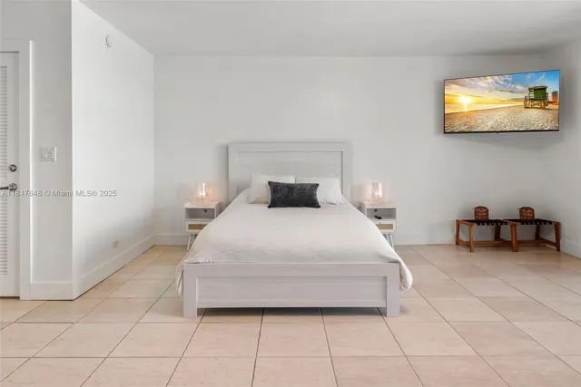 a bedroom with a bed and a flat screen tv