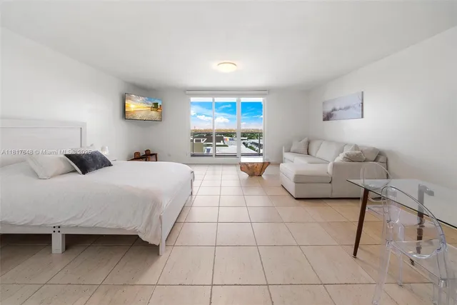 a bedroom with a bed and a couch