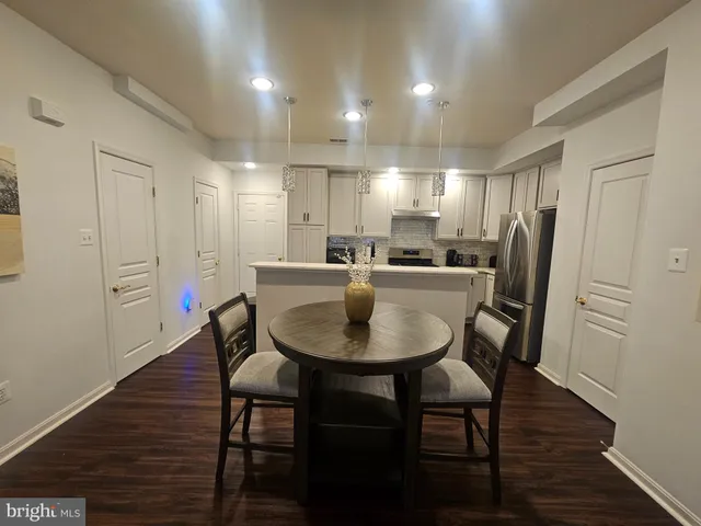 a view of a a dining room with furniture window and wooden floor