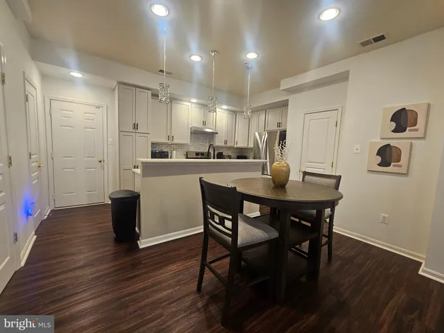 a kitchen with a table and chairs in it