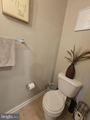 a white toilet sitting next to a bathroom sink