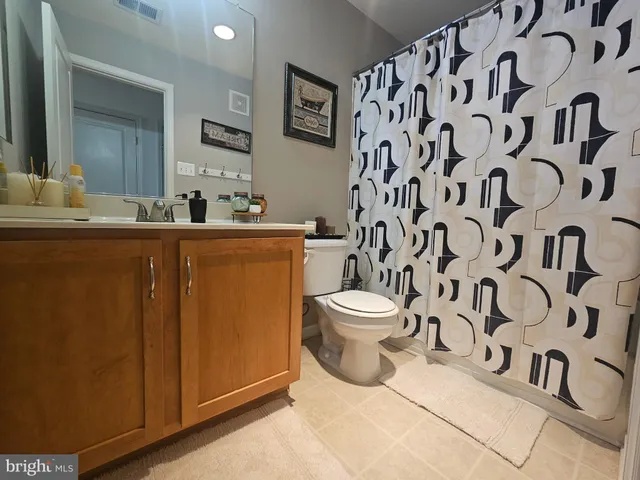 a white toilet sitting next to a bathroom sink