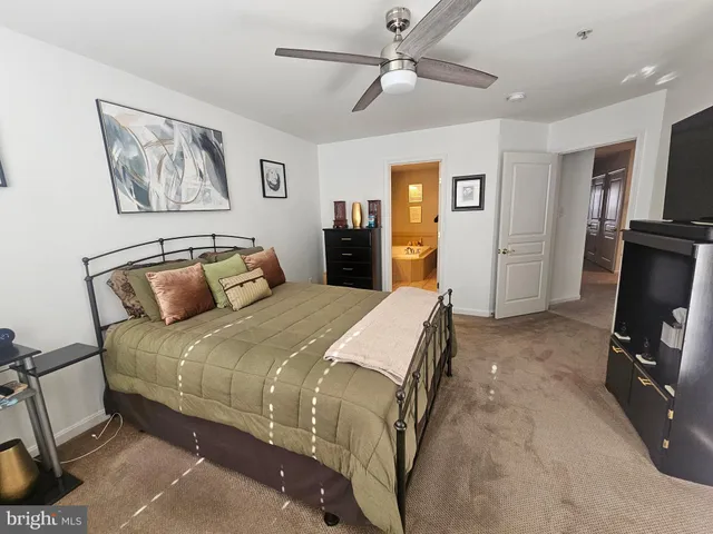 a bedroom with a large bed and a tv