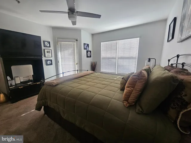 a bedroom with a bed and a television