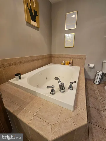 a bath tub sitting in a bathroom next to a sink