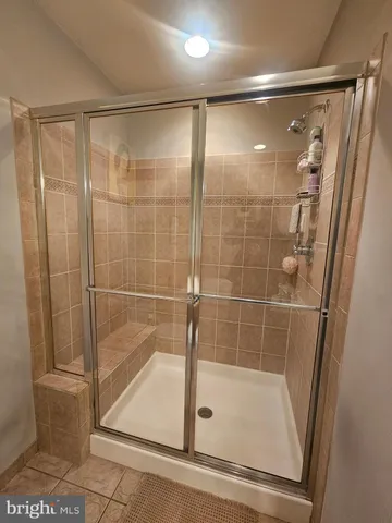 a bathroom with a glass shower door