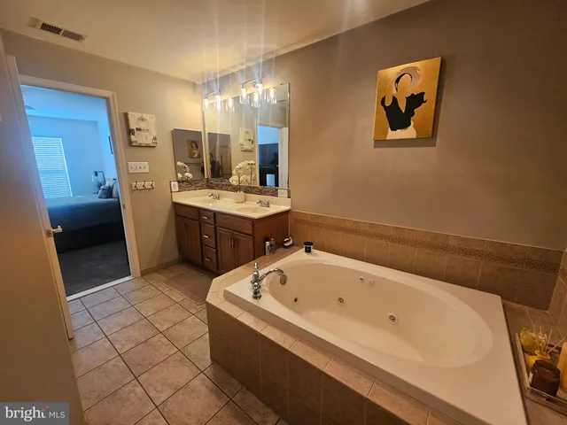 a bathroom with a tub a sink and a shower