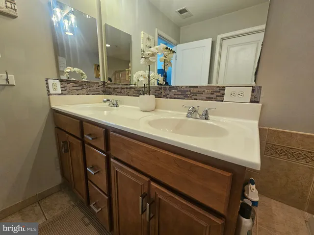 a bathroom with a sink double vanity and a mirror