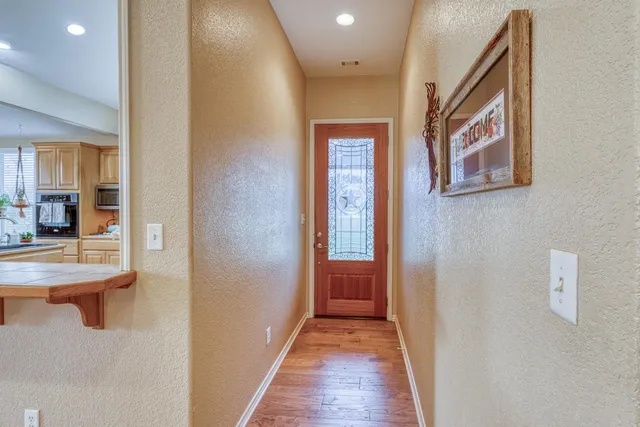 a living room with furniture fireplace and potted plant