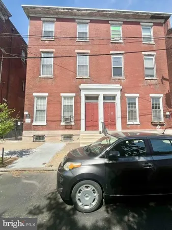 a front view of a house with parking space