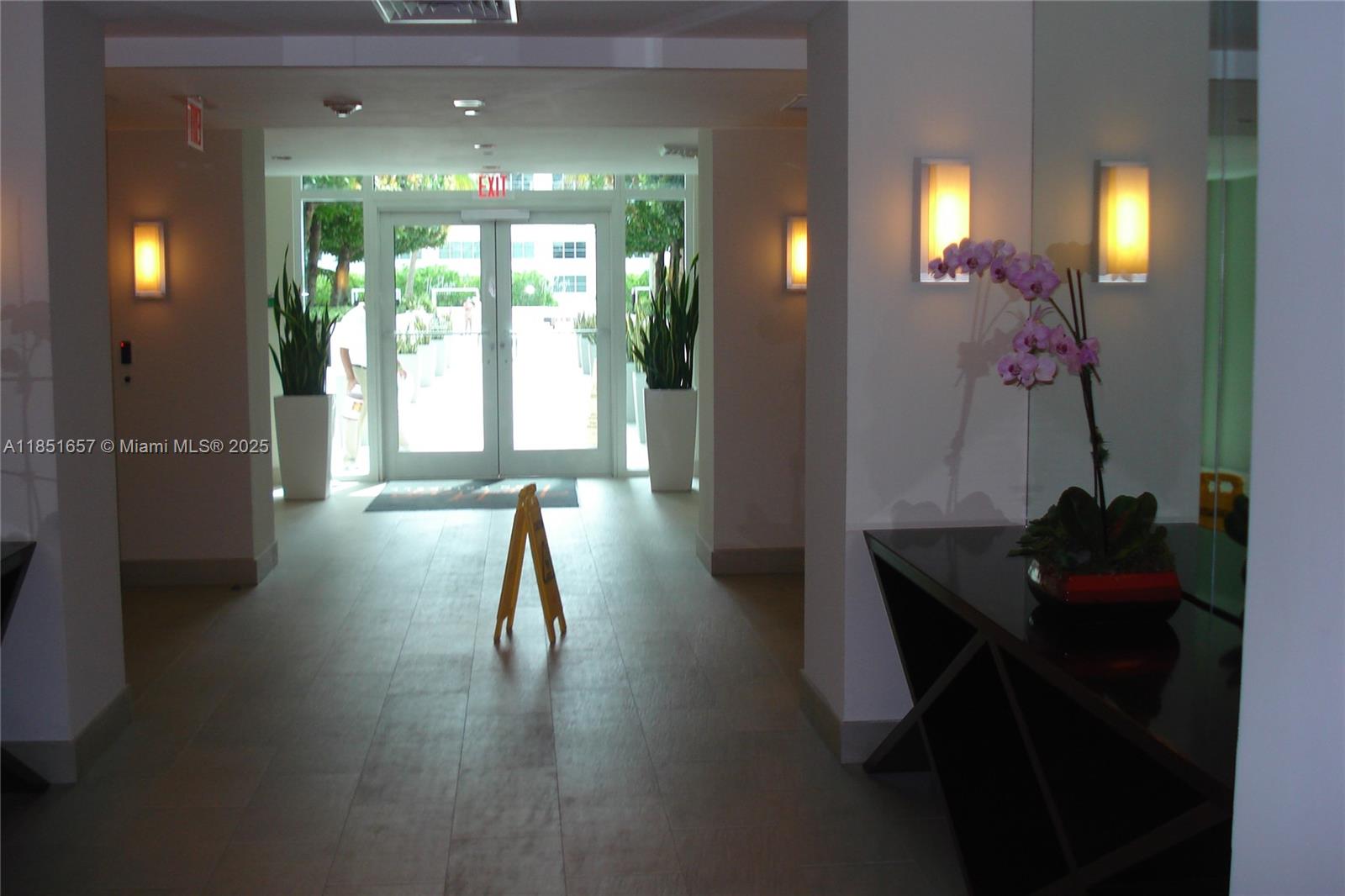 951 Brickell Avenue, Unit 1007 Miami, FL 33131 - Photo 2 of 25 a hallway with a view of dining room and wooden floor