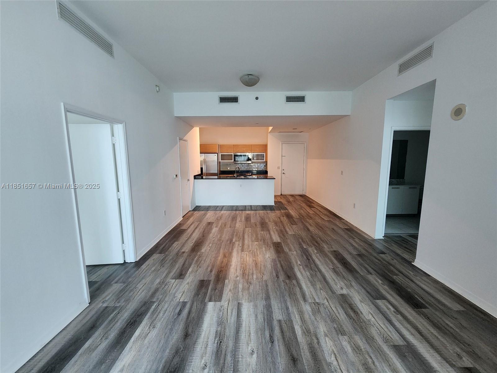 951 Brickell Avenue, Unit 1007 Miami, FL 33131 - Photo 24 of 25 a view of empty room with wooden floor