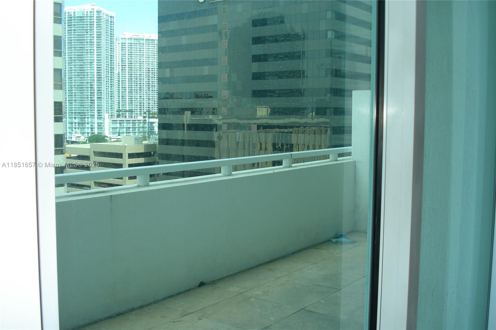 951 Brickell Avenue, Unit 1007 Miami, FL 33131 - Photo 4 of 25 a view of a green room with windows