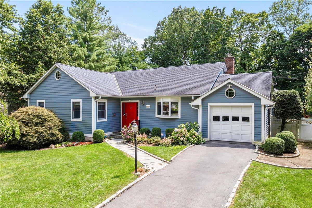 a front view of a house with a yard and porch