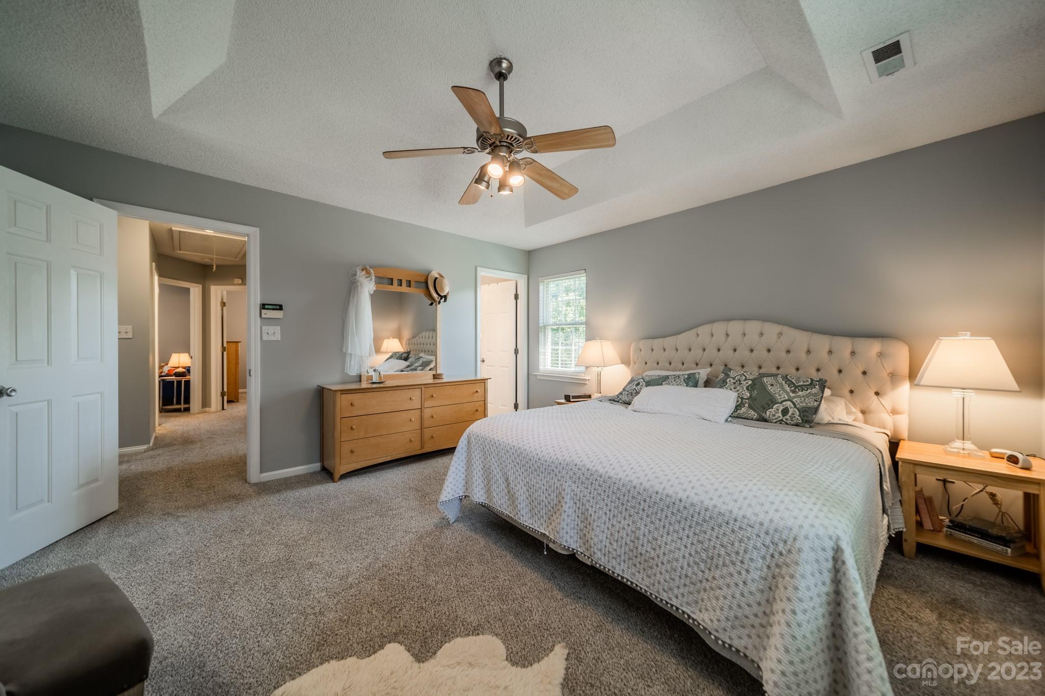 107 Howe Street Belmont, NC 28012 - Photo 16 of 35 a bedroom with a bed and a chandelier