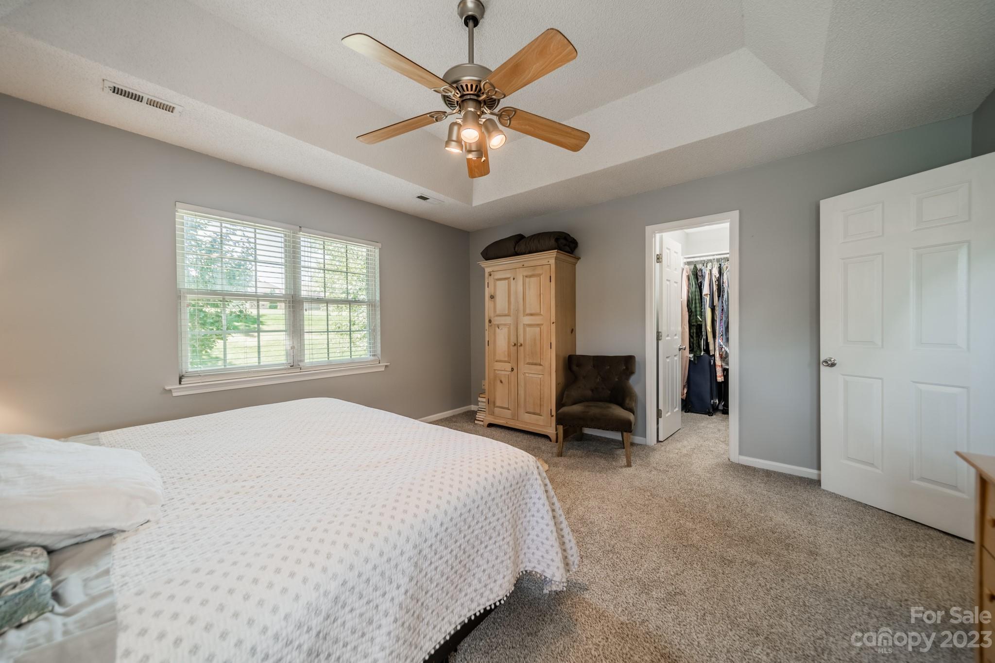 107 Howe Street Belmont, NC 28012 - Photo 17 of 35 a bedroom with a bed a large window and ceiling fan