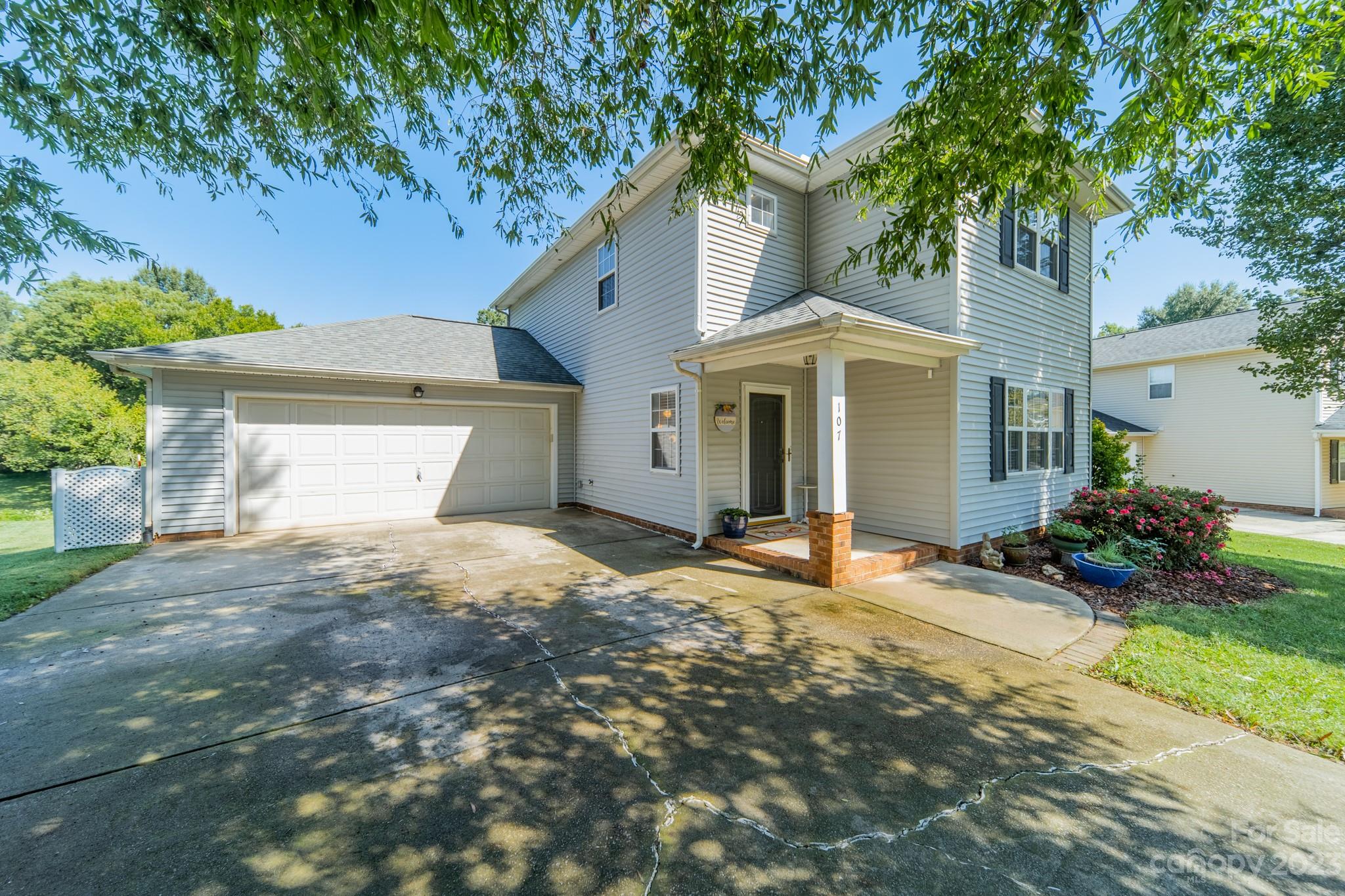 107 Howe Street Belmont, NC 28012 - Photo 2 of 35 a front view of a house with a yard and garage