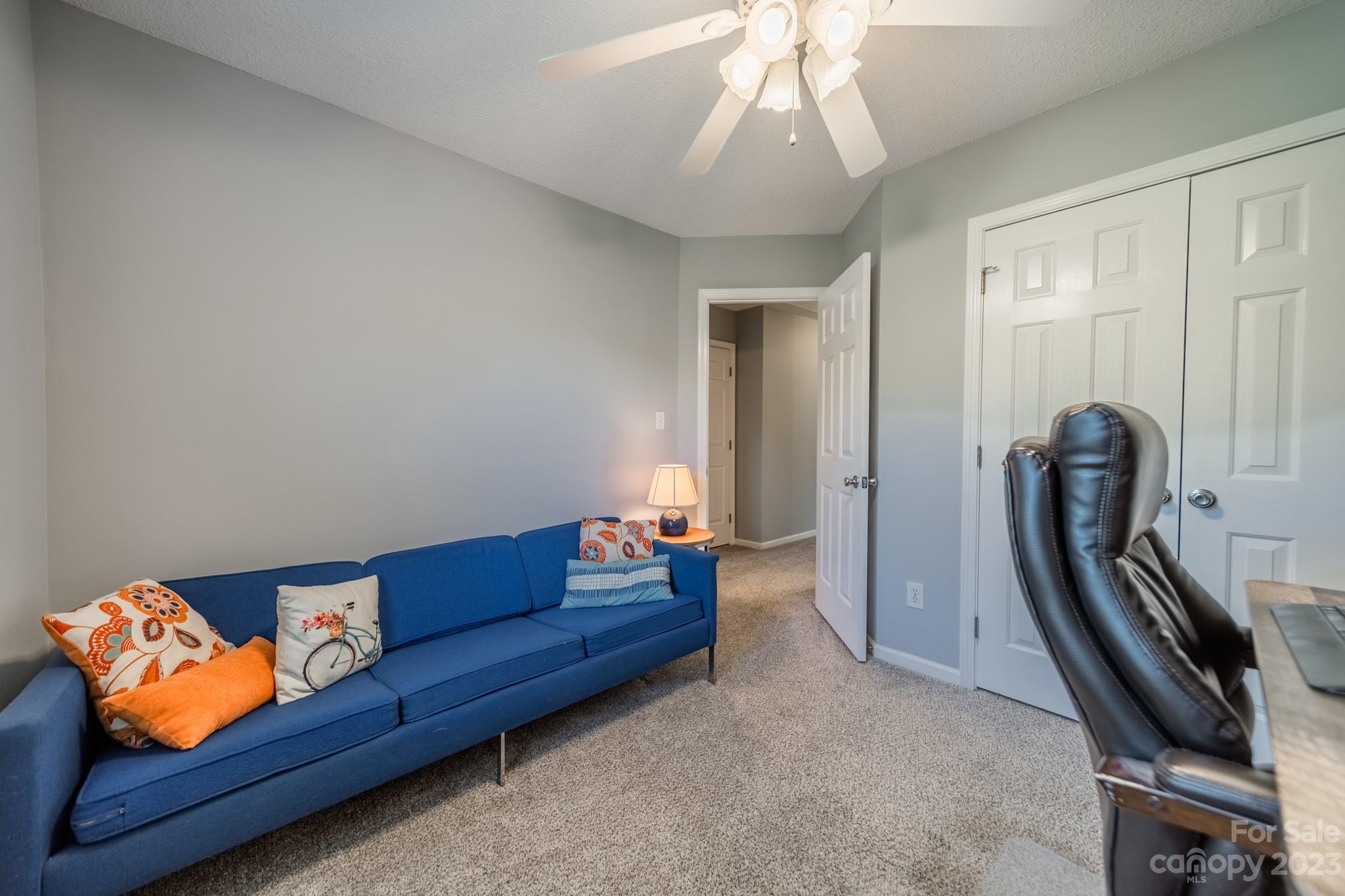 107 Howe Street Belmont, NC 28012 - Photo 21 of 35 a living room with furniture and a chandelier