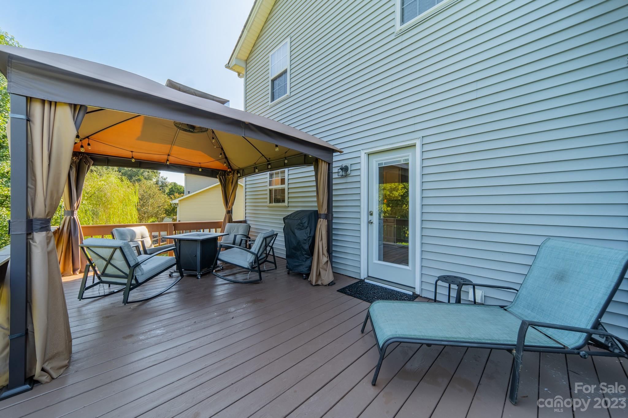 107 Howe Street Belmont, NC 28012 - Photo 25 of 35 a view of a patio with table and chairs and wooden floor