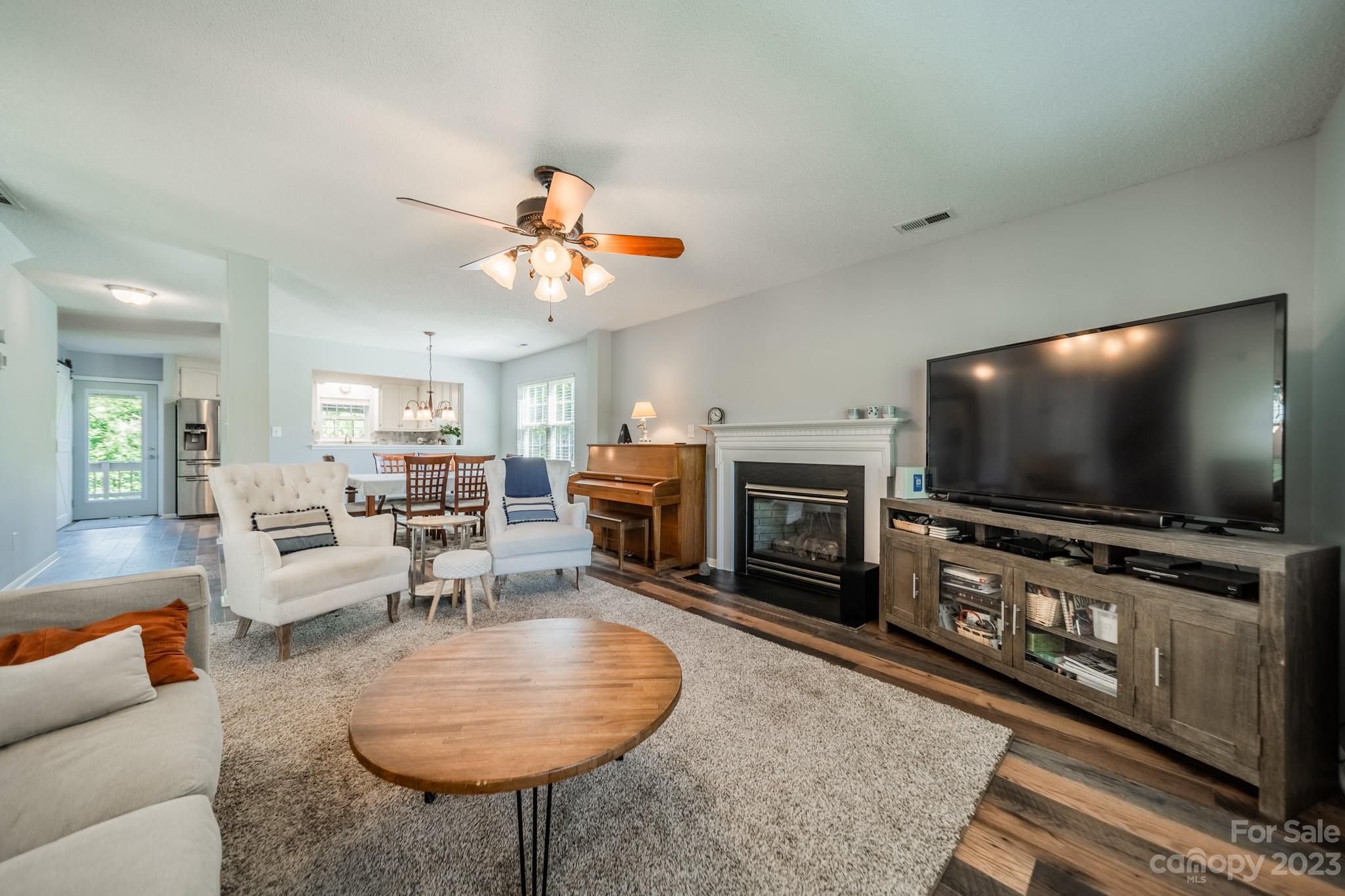 107 Howe Street Belmont, NC 28012 - Photo 5 of 35 a living room with furniture and a flat screen tv