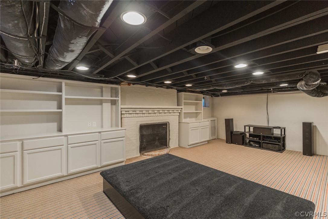 3814 Dover Road Richmond, VA 23221 - Photo 38 of 48 The finished basement rec room features a brick fi