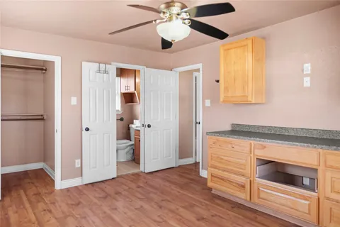 a bedroom with a bed and a ceiling fan