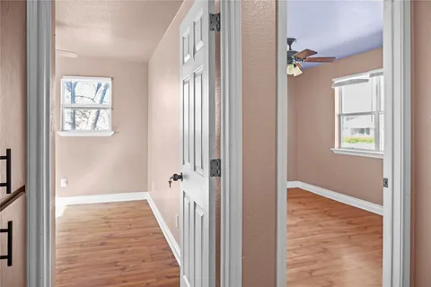 a view of a hallway with windows and entryway