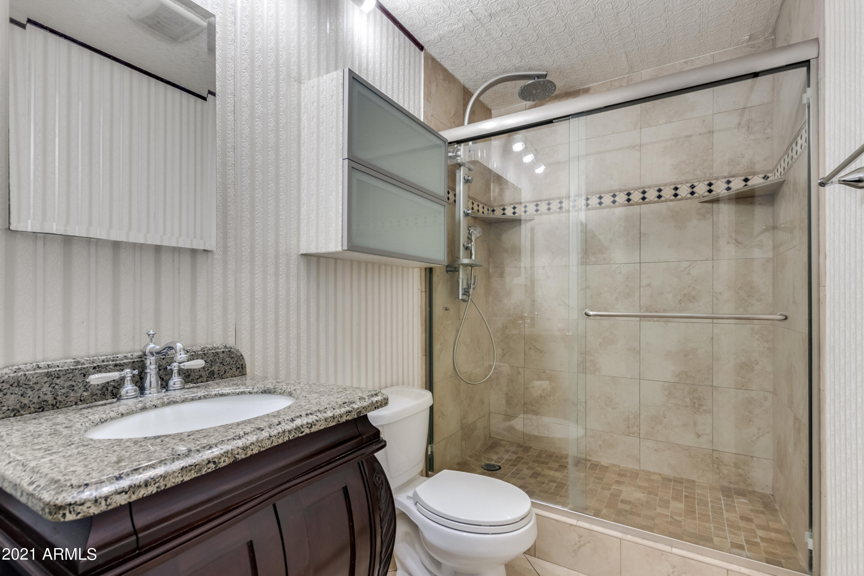 700 East Mesquite Circle, Unit R123 Tempe, AZ 85288 - Photo 11 of 28 a bathroom with a granite countertop sink a toilet and shower