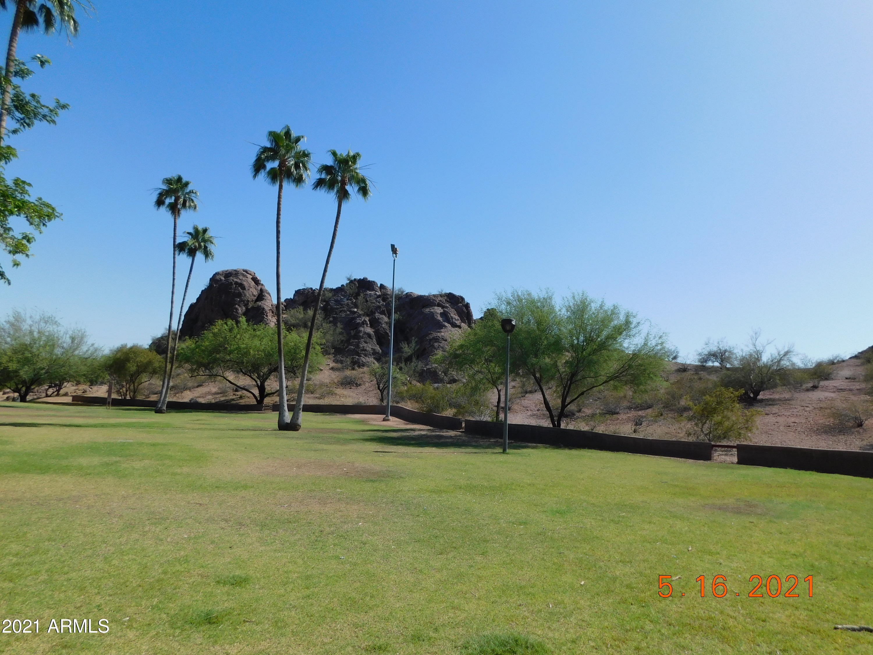 700 East Mesquite Circle, Unit R123 Tempe, AZ 85288 - Photo 23 of 28 a view of a golf course with a lake