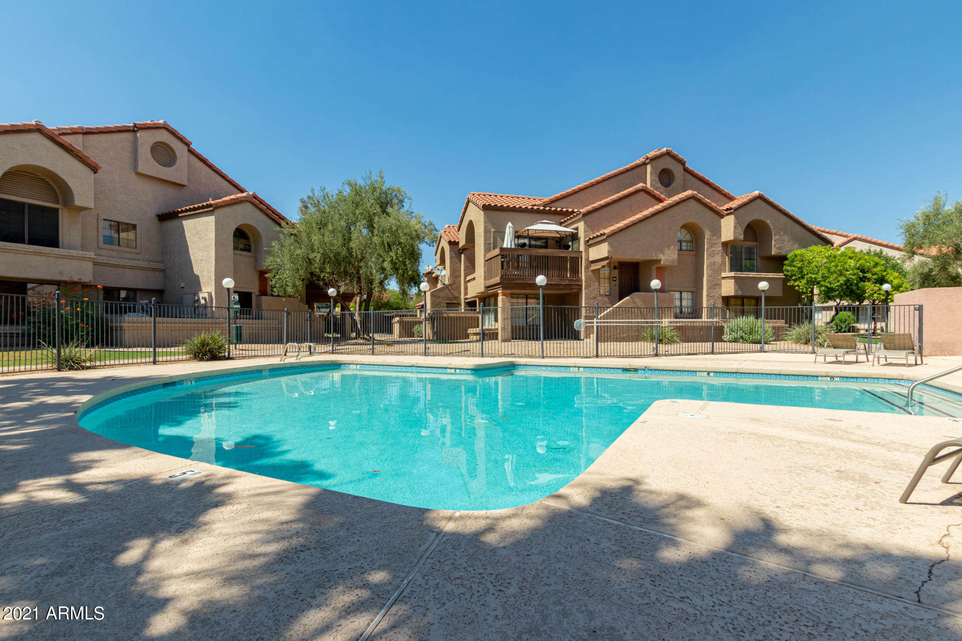 700 East Mesquite Circle, Unit R123 Tempe, AZ 85288 - Photo 26 of 28 a view of a house with a swimming pool