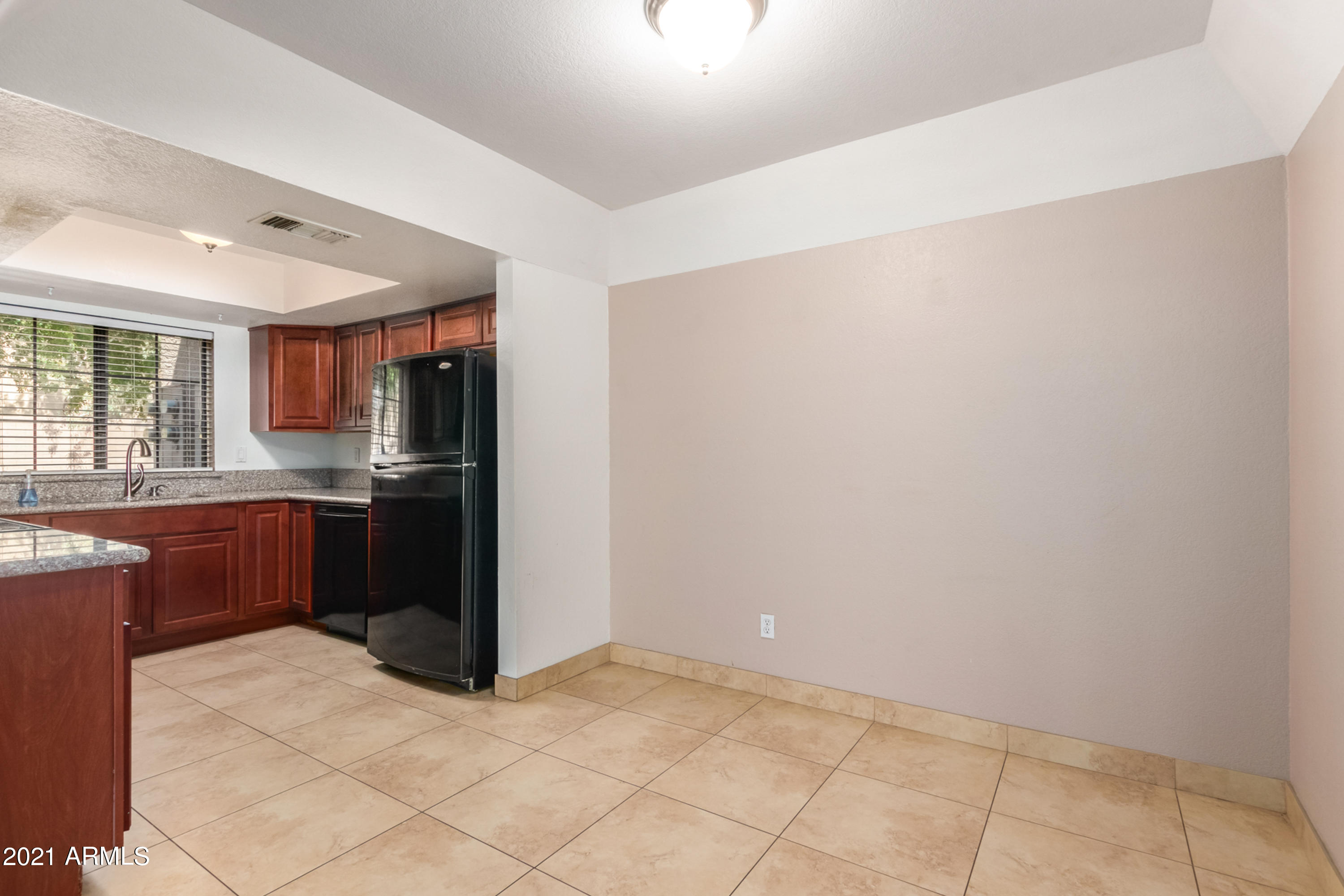 700 East Mesquite Circle, Unit R123 Tempe, AZ 85288 - Photo 7 of 28 a kitchen with granite countertop a refrigerator and a sink