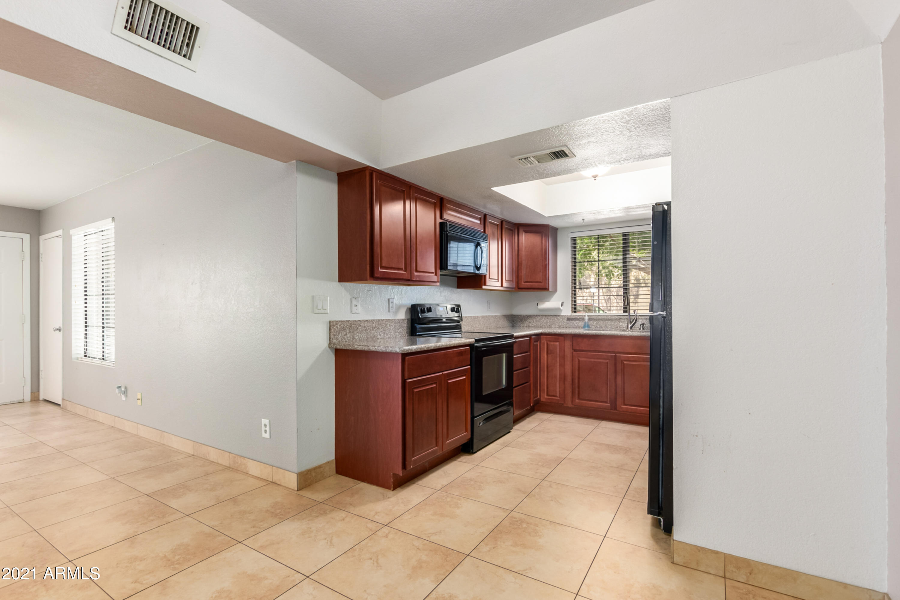 700 East Mesquite Circle, Unit R123 Tempe, AZ 85288 - Photo 8 of 28 a kitchen with stainless steel appliances granite countertop a refrigerator and a stove top oven