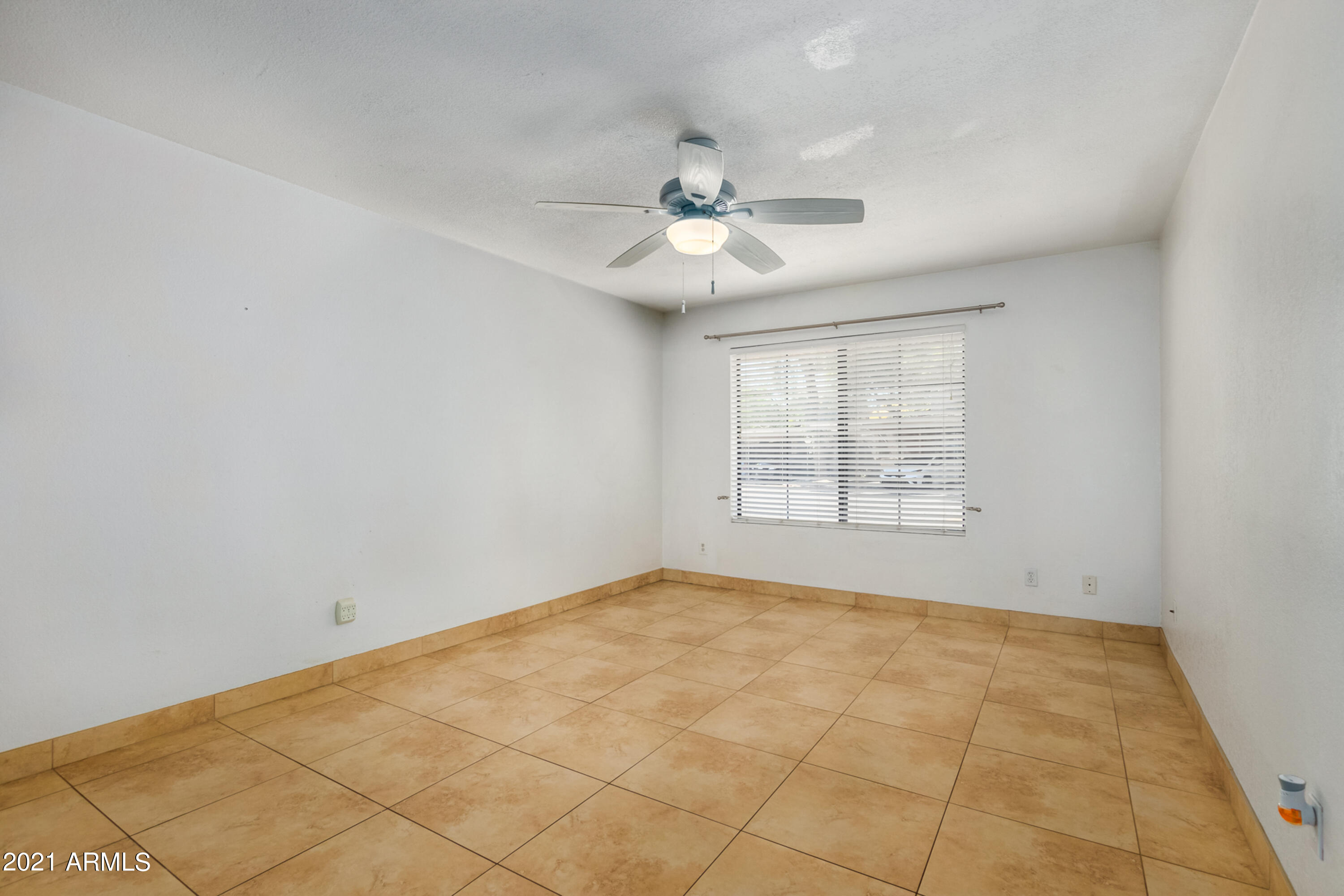 700 East Mesquite Circle, Unit R123 Tempe, AZ 85288 - Photo 9 of 28 an empty room with windows and fan