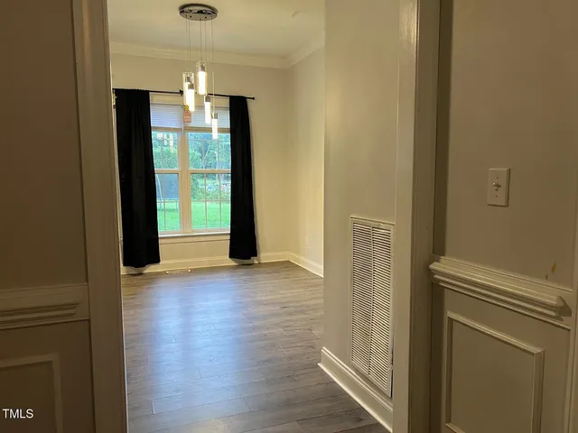 a spacious bedroom with a bed and a chair