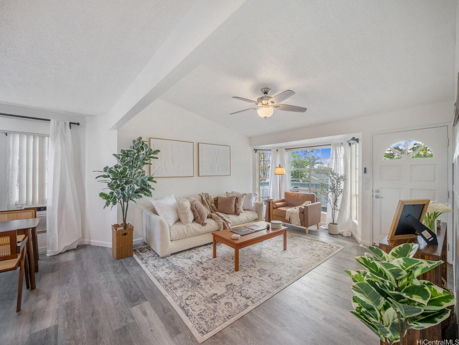 594 Mananai Place, Unit 21T Honolulu, HI 96818 - Photo 1 of 25 a living room with furniture and a potted plant