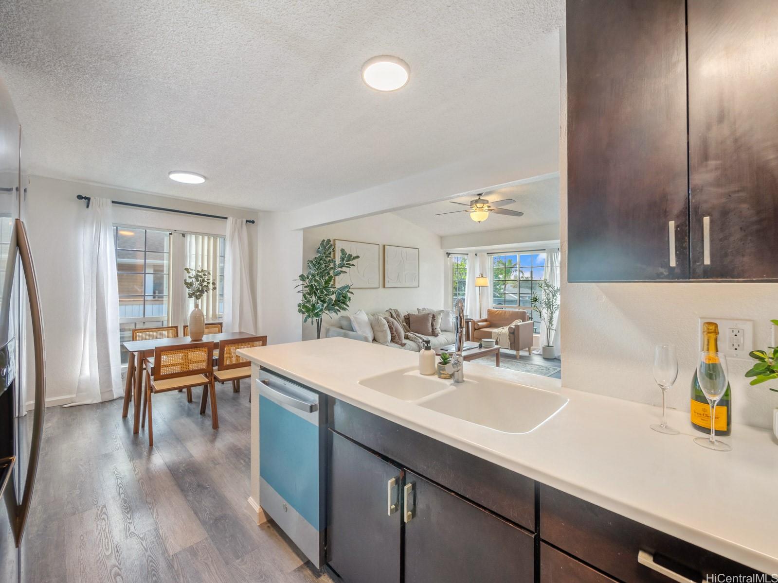 594 Mananai Place, Unit 21T Honolulu, HI 96818 - Photo 11 of 25 a kitchen with a sink dining table and chairs