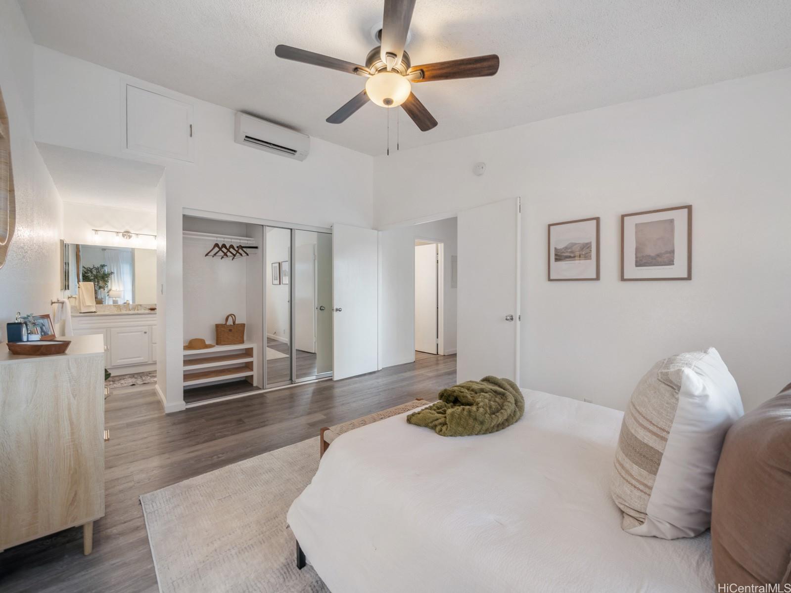 594 Mananai Place, Unit 21T Honolulu, HI 96818 - Photo 15 of 25 a bedroom with a bed and a chandelier