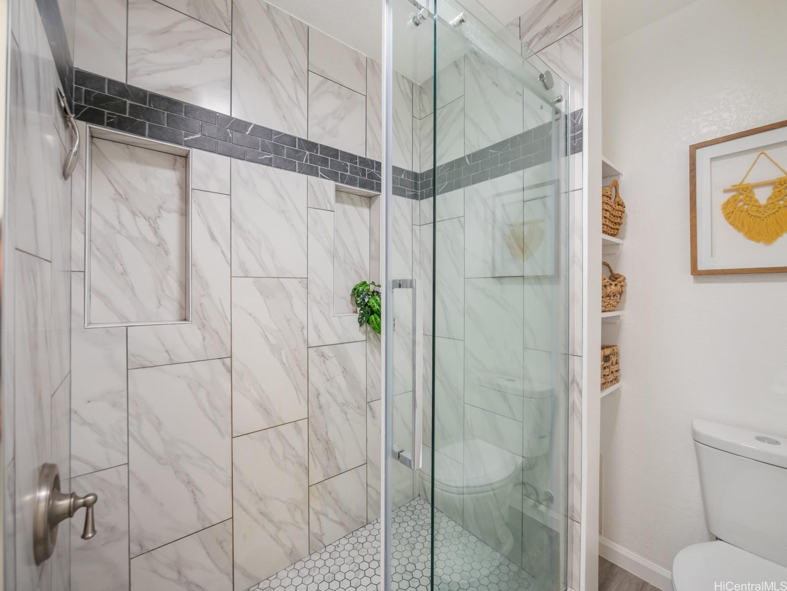 594 Mananai Place, Unit 21T Honolulu, HI 96818 - Photo 17 of 25 a bathroom with a shower and toilet