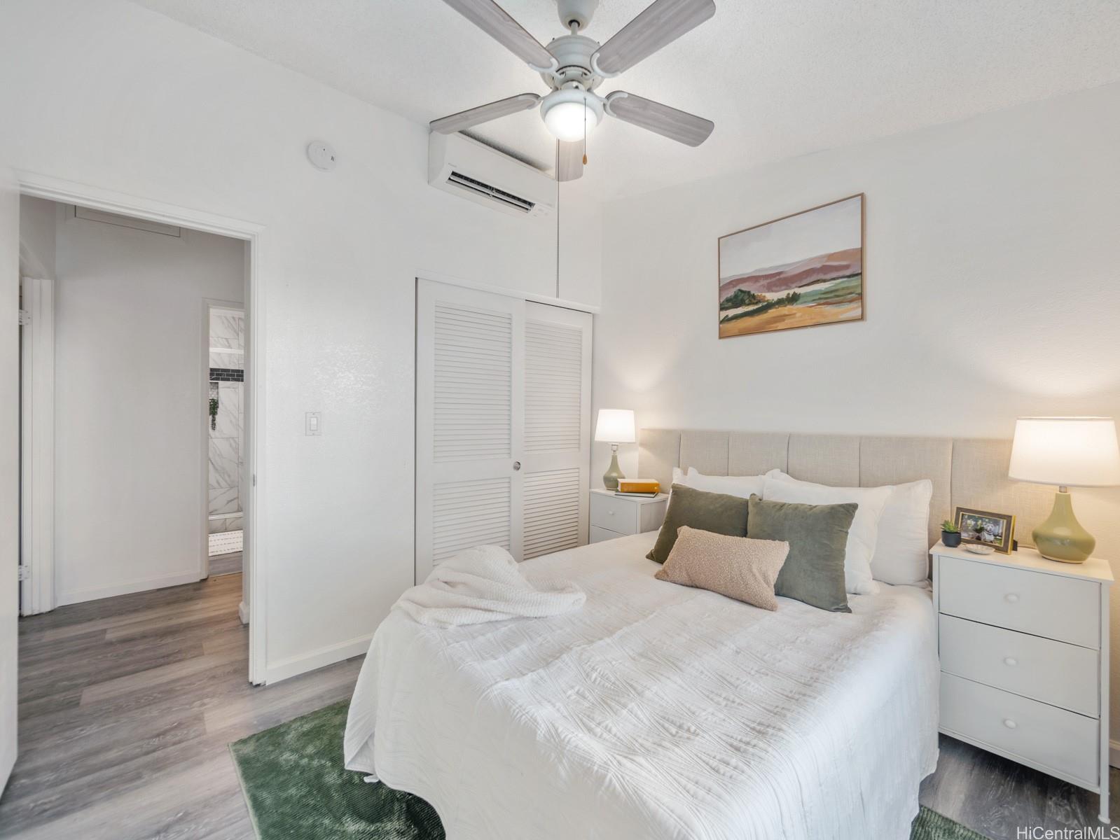 594 Mananai Place, Unit 21T Honolulu, HI 96818 - Photo 19 of 25 a bedroom with a bed and a ceiling fan