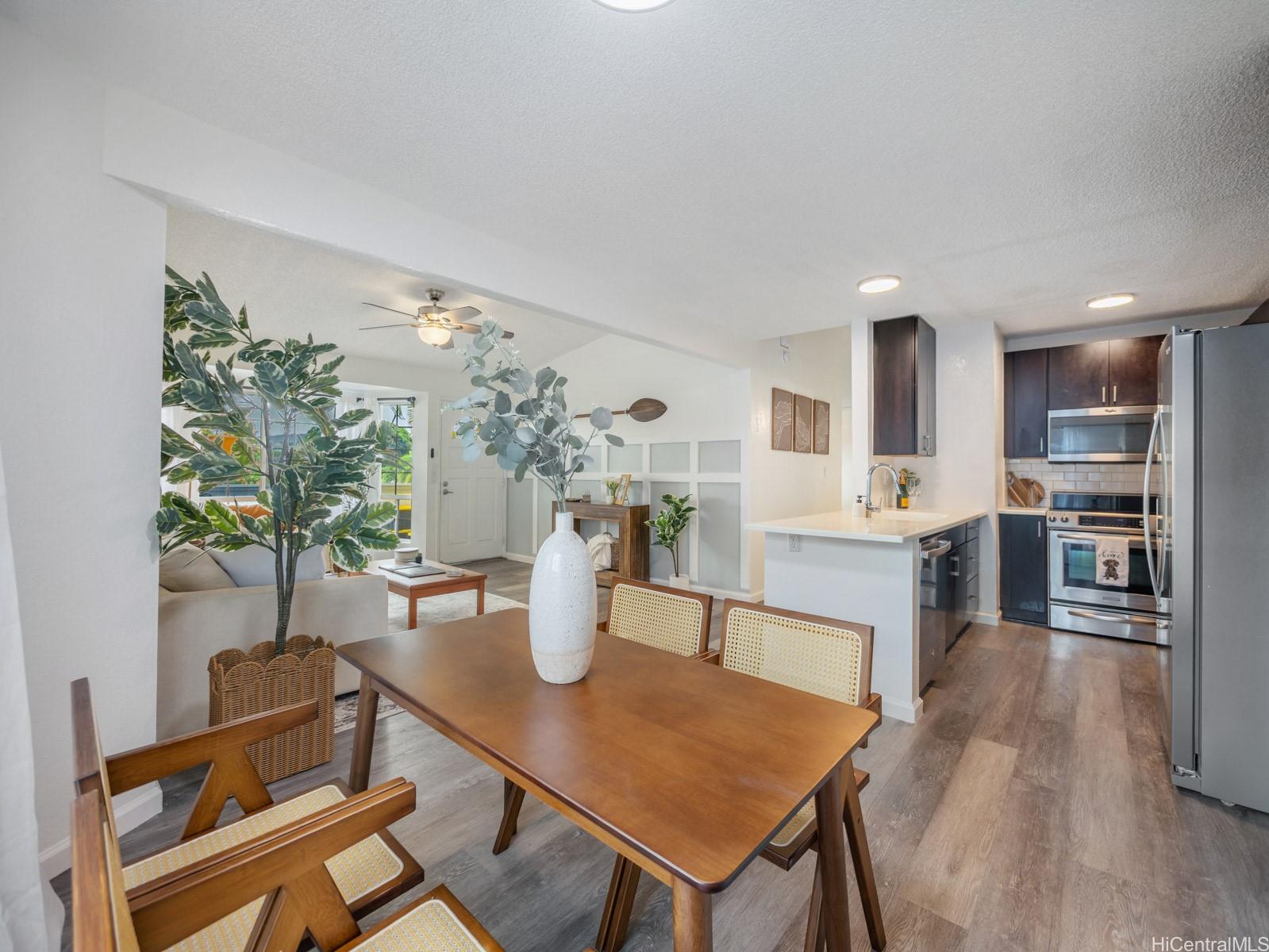 594 Mananai Place, Unit 21T Honolulu, HI 96818 - Photo 8 of 25 a view of a dining room with furniture and a chandelier