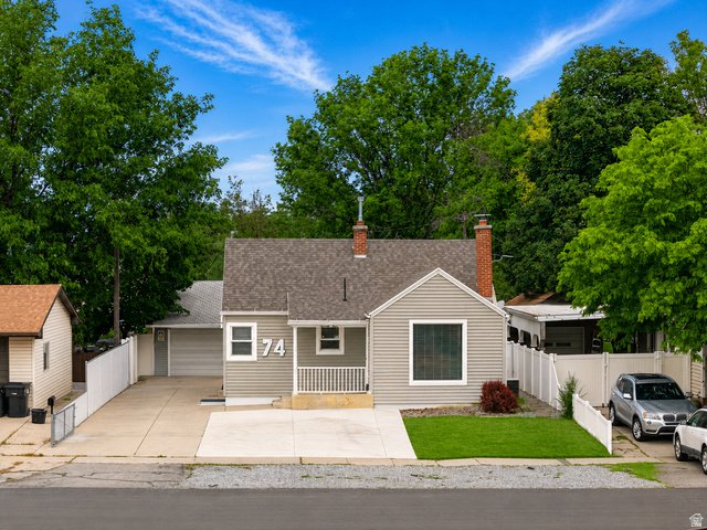 Single-story residence featuring light gray siding and a composition shingle roof