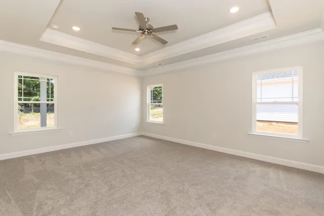 an empty room with a ceiling fan and a window