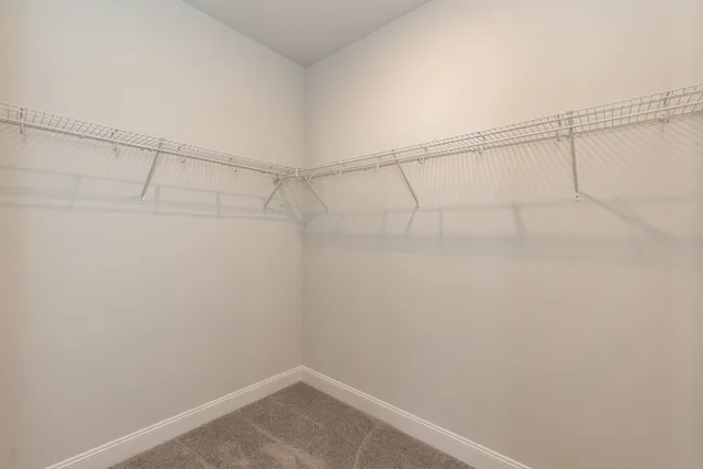 a bathroom with a granite countertop bathtub shower sink vanity mirror and toilet
