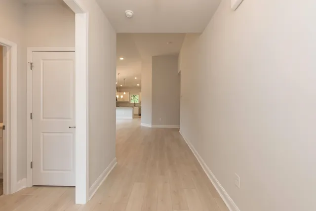 a view of a hallway with wooden floor