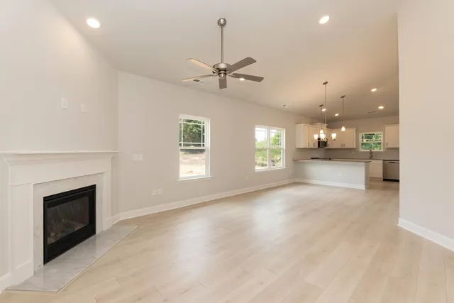 a view of a livingroom with a ceiling fan and fireplace