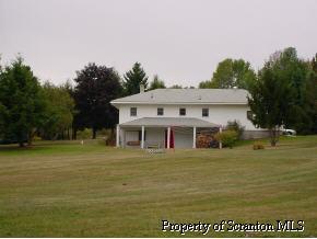 606 Silkmans Road Lake Ariel, PA 18436 - Photo 5 of 5 a front view of a house with a garden